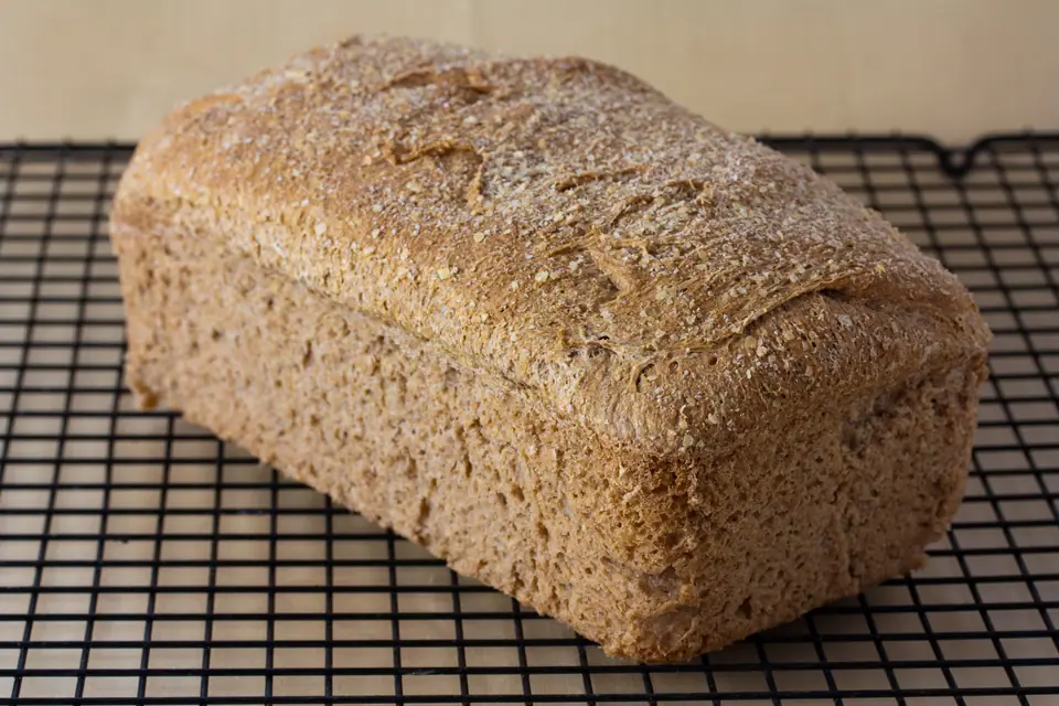 Pan de molde integral recién horneado enfriándose sobre una rejilla
